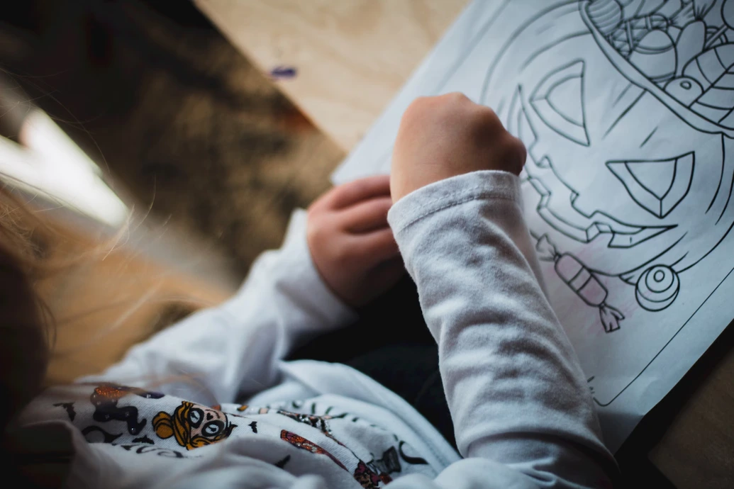 A child coloring with crayons
